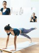 A woman doing a yoga pose on a yoga mat.